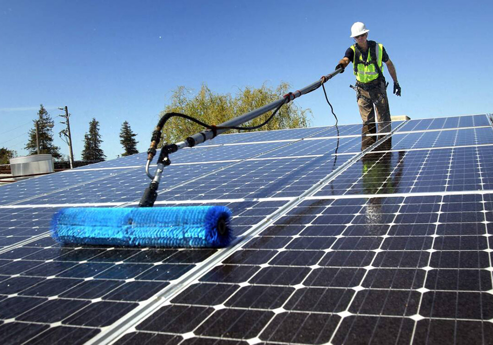 Technician maintaining solar panels